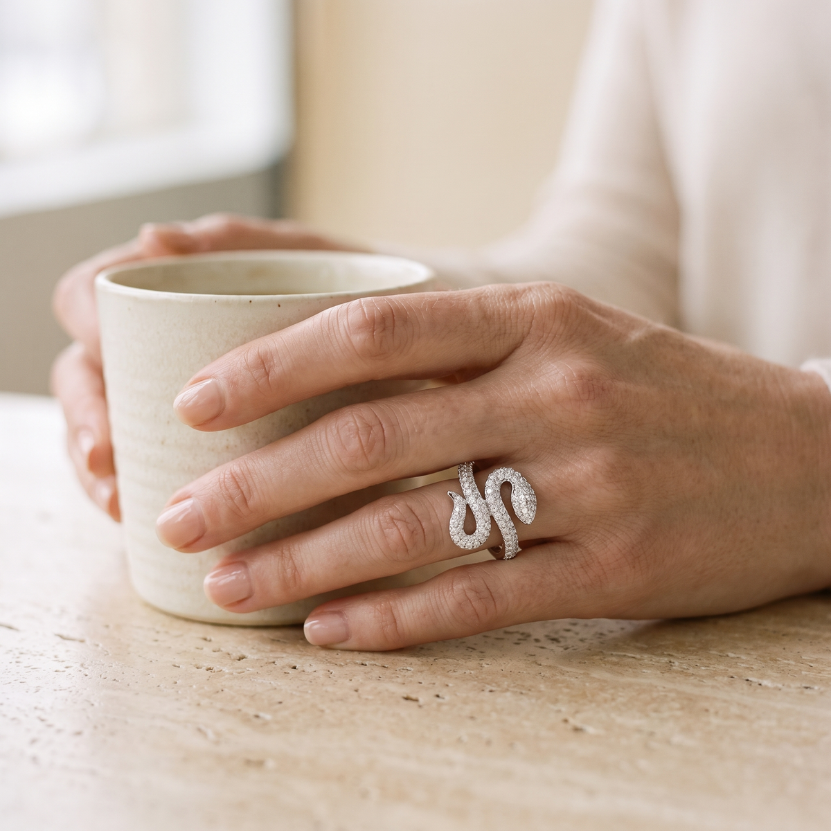 Coiled snake ring worn on a woman's hand