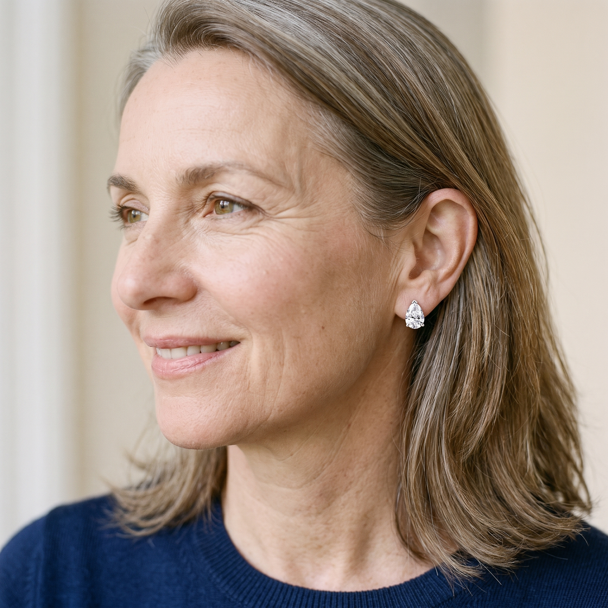 Blanche Pear-Cut Moissanite Studs, worn by a woman