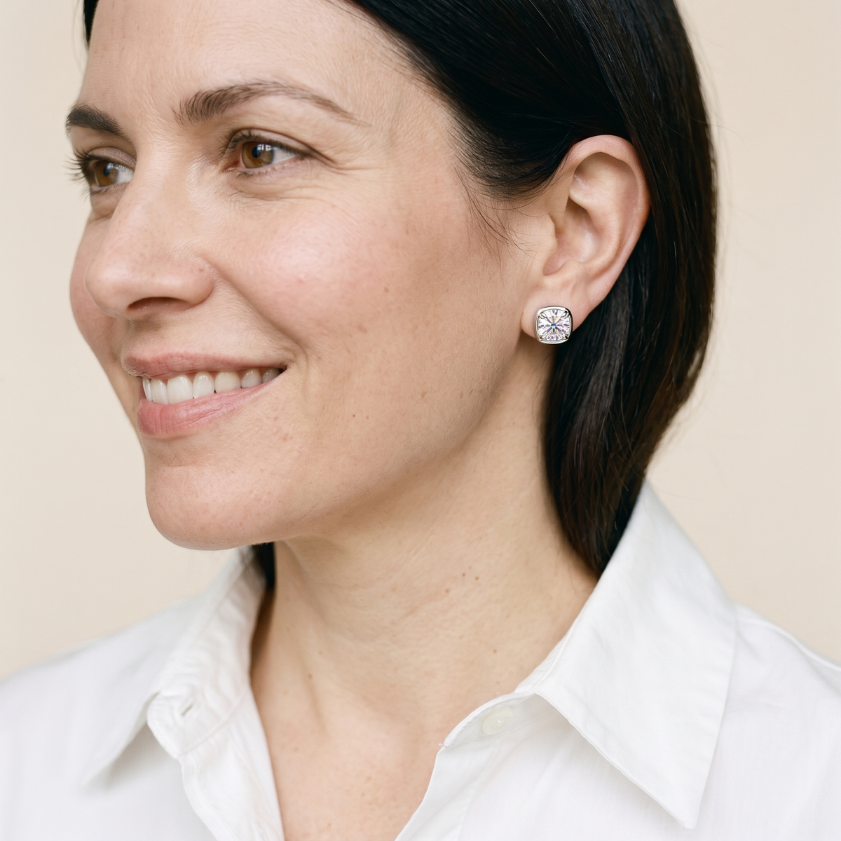 Camille Cushion Bezel Moissanite Studs, worn by a woman