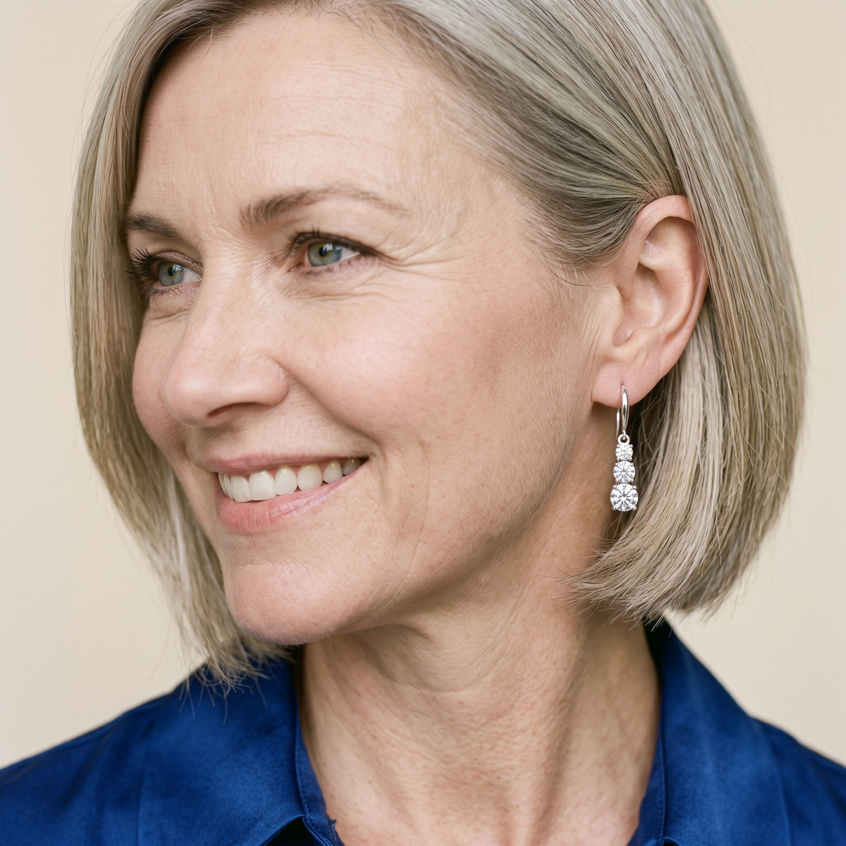 Cascade Three-Stone Moissanite Drop Earrings, worn by a woman