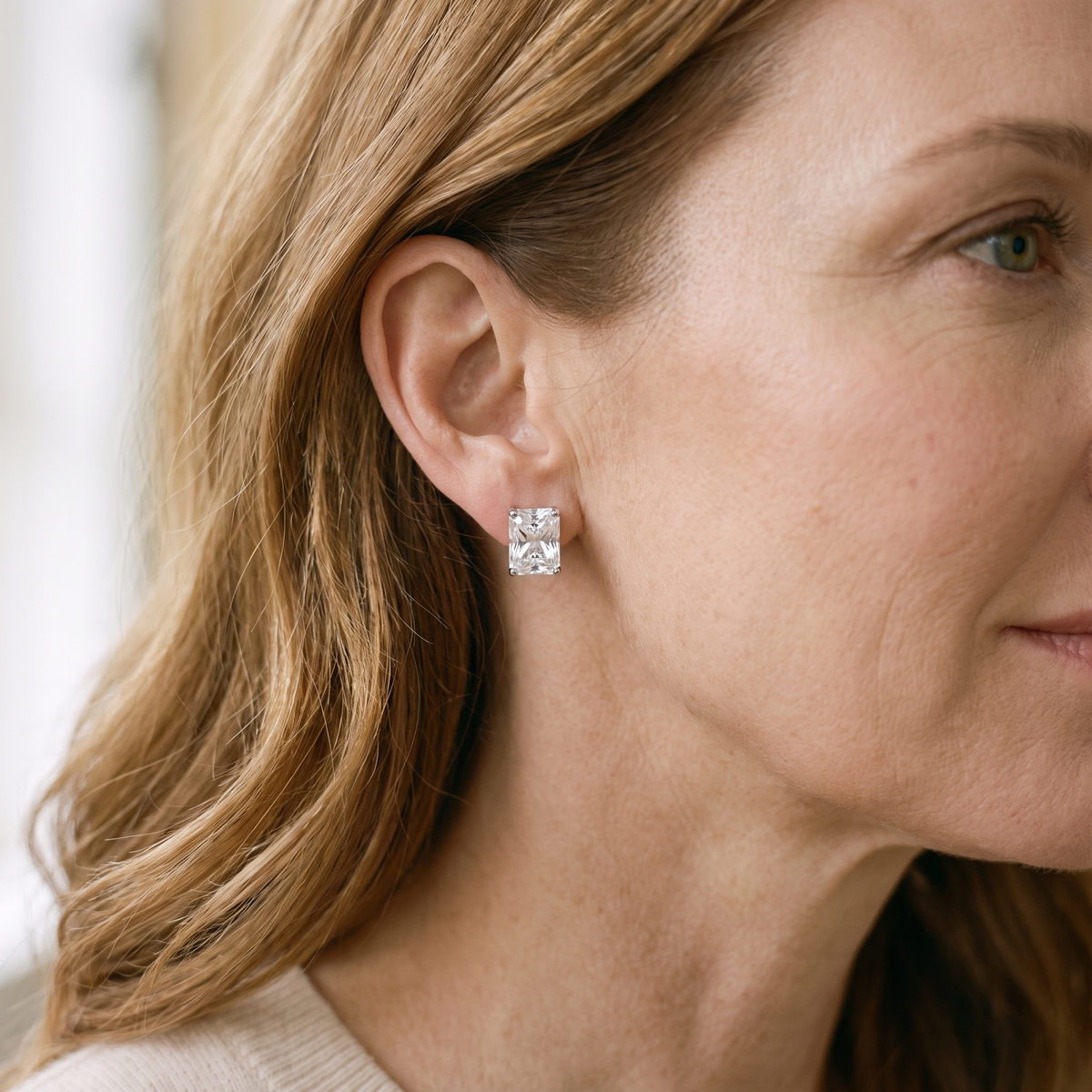 Éclat Radiant-Cut Moissanite Studs, worn by a woman
