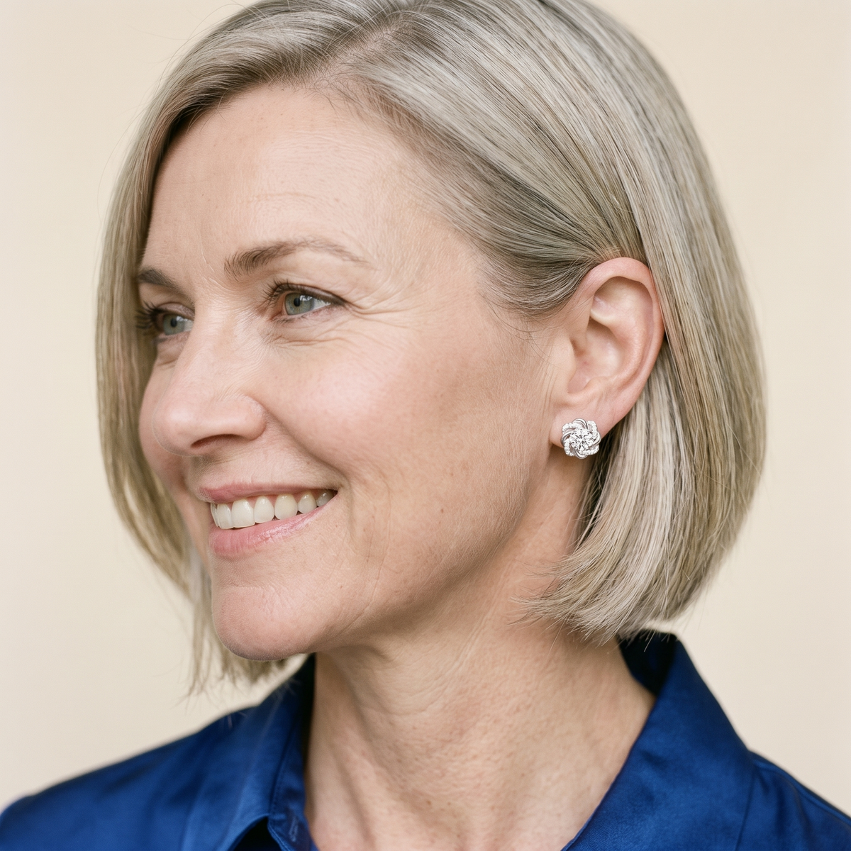 Églantine Moissanite Swirl Flower Studs, worn by a woman