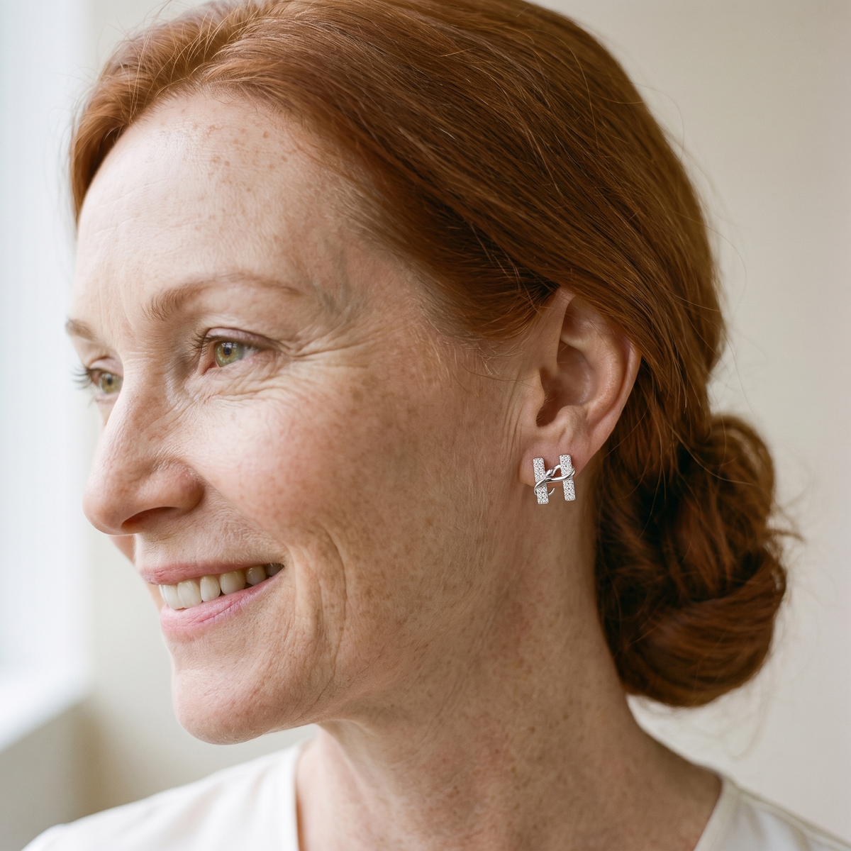 Hermine Moissanite H Snake Studs, worn by a woman