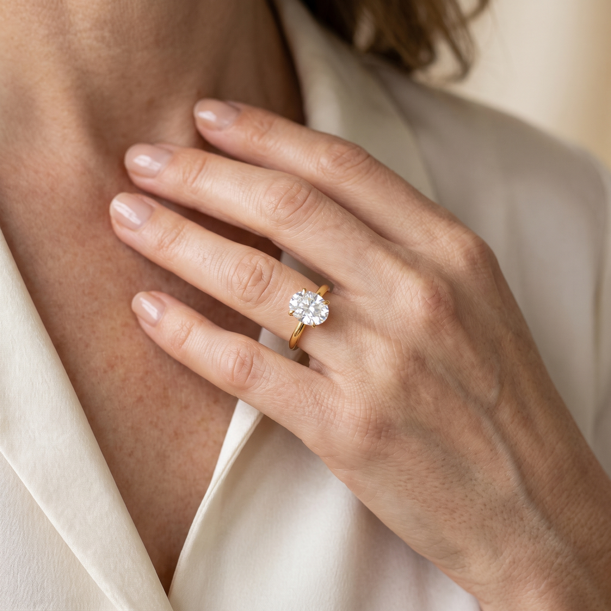 Olympe Oval Moissanite Engagement Ring, worn by a woman