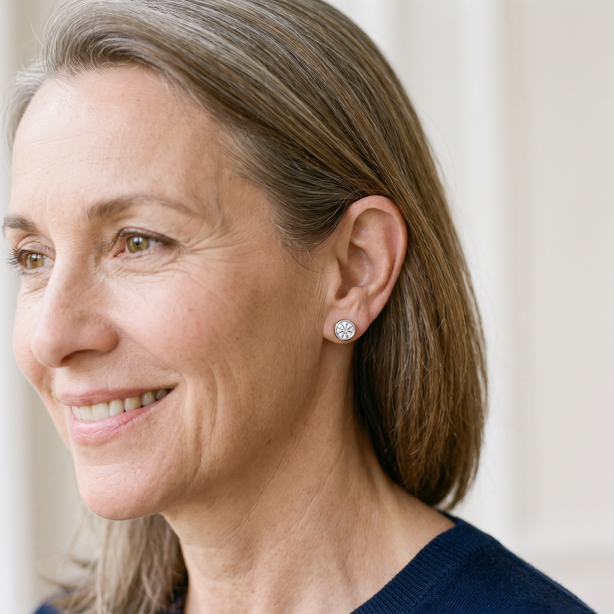 Orbe Bezel Moissanite Studs, worn by a woman