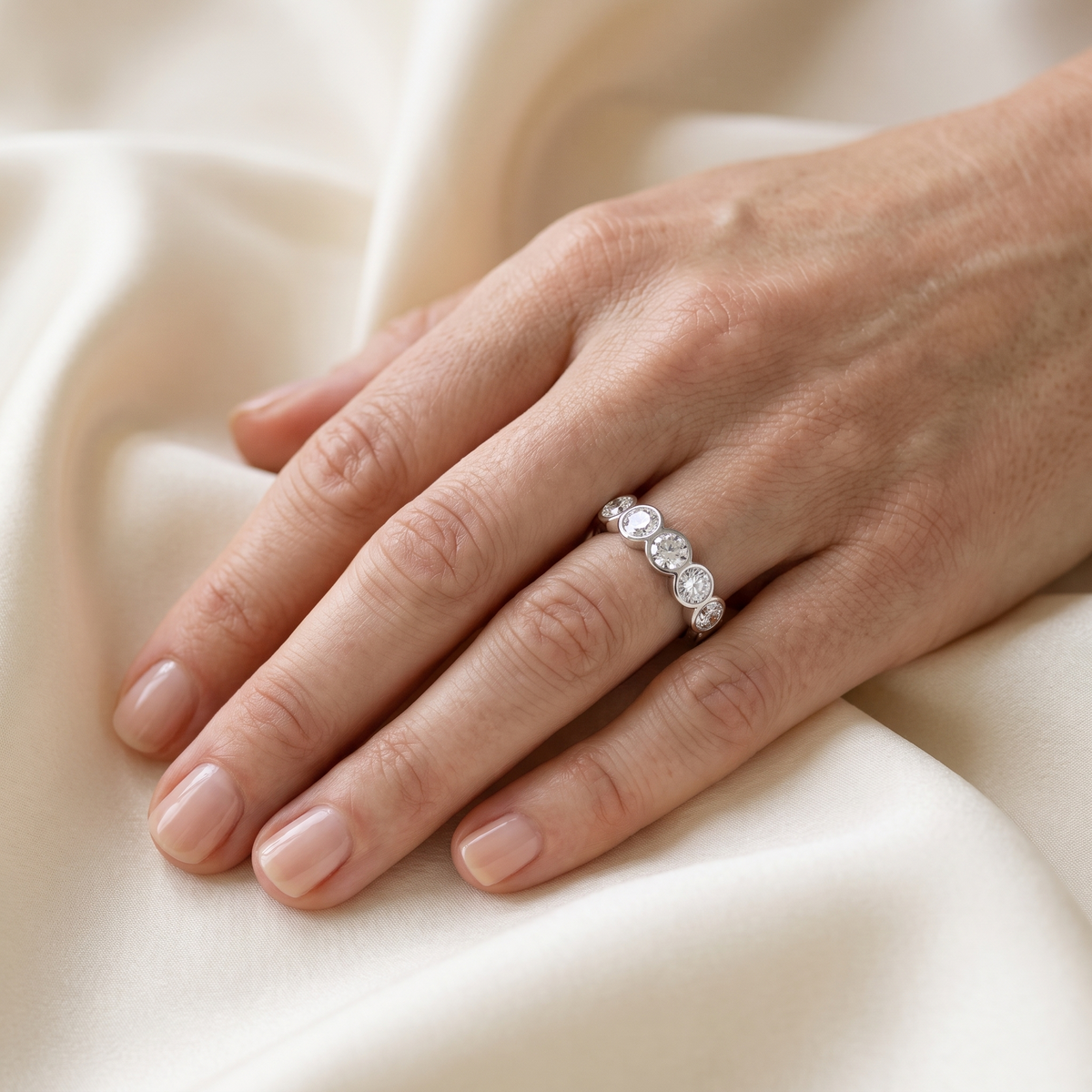 Quintette Five-Stone Bezel Moissanite Band, worn by a woman